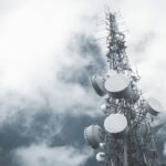 Telecommunication tower against a cloudy sky