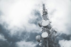 Telecommunication tower against a cloudy sky