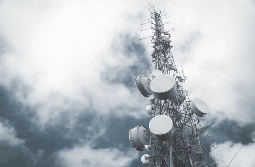 Telecommunication tower against a cloudy sky