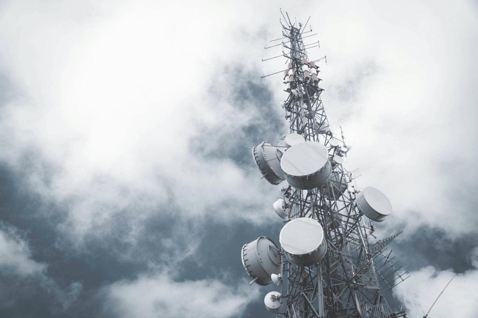 Telecommunication tower against a cloudy sky
